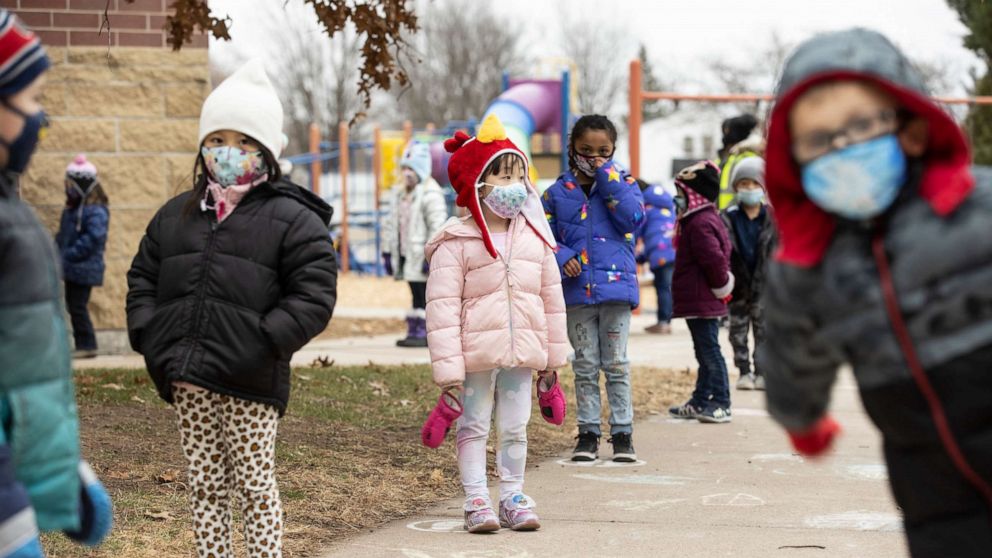 PHOTO: Students line up on designated spots after recess before returning to their classrooms at G.D. Jones Elementary in Wausau, Wis., Dec. 7, 2020.