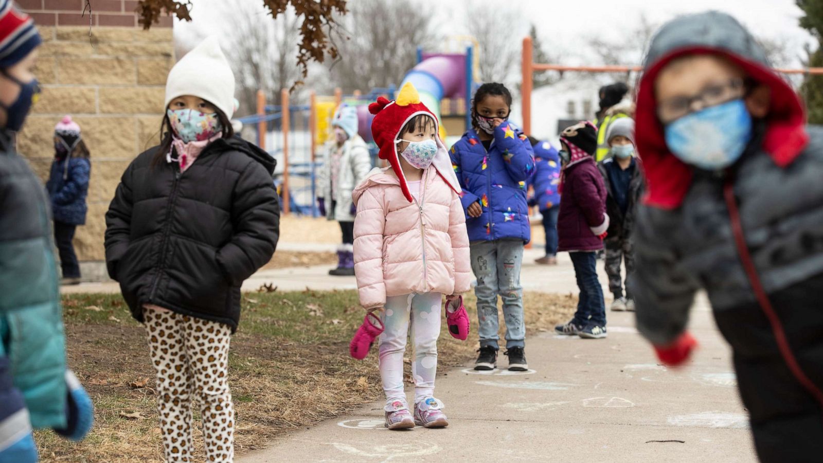 PHOTO: Students line up on designated spots after recess before returning to their classrooms at G.D. Jones Elementary in Wausau, Wis., Dec. 7, 2020.