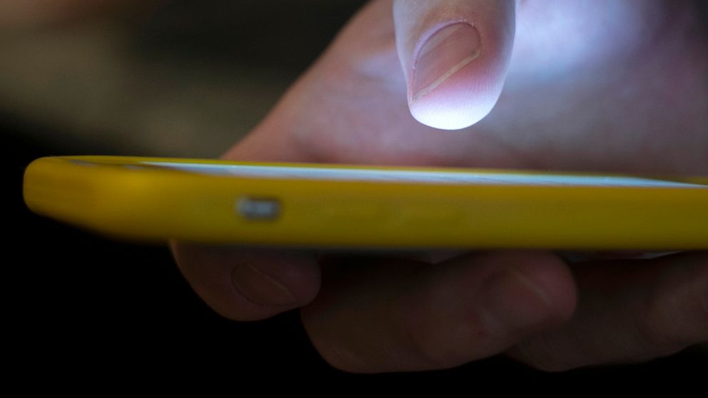 PHOTO: A man uses a cell phone in New Orleans, Aug. 11, 2019.