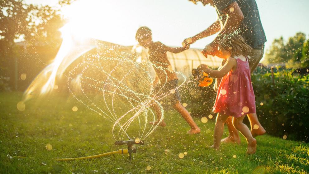 PHOTO: A father plays with children running through a in an undated stock photo. 
