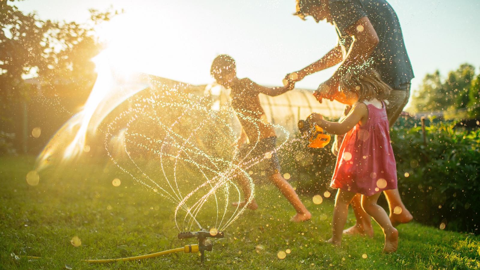 PHOTO: A father plays with children running through a in an undated stock photo.