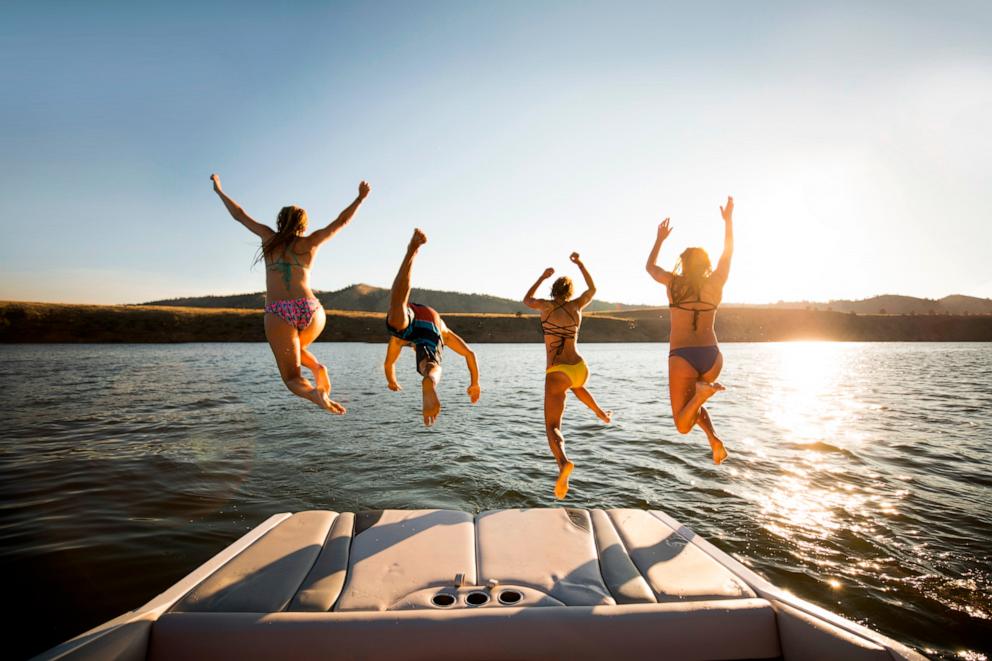 PHOTO: Stock photo of a group jumping of a boat.