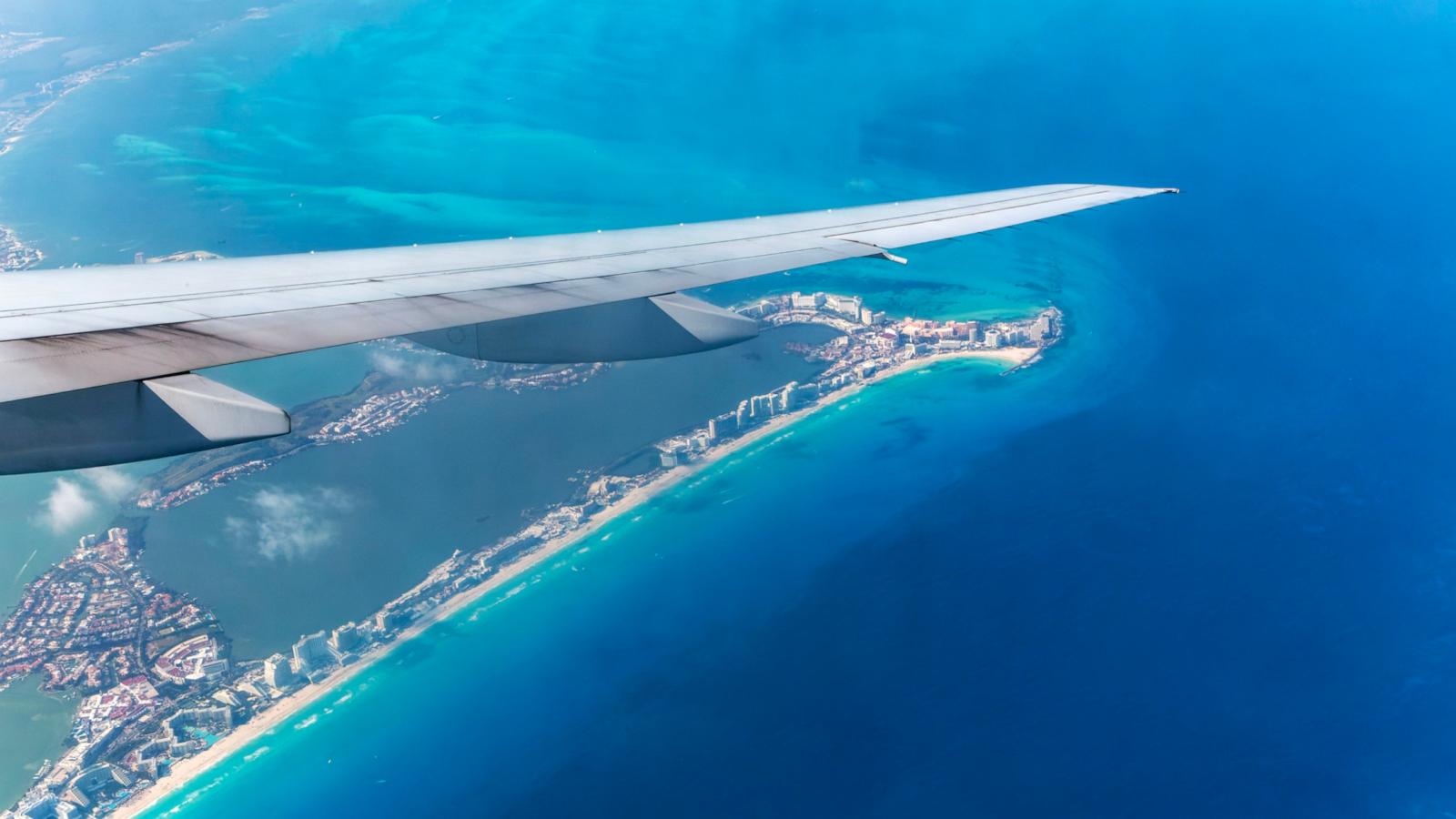 PHOTO: Aerial view through plane window of Caribbean coastline buildings in the hotel zone, Cancun, Quintana Roo, Yucatan Peninsula, Mexico.