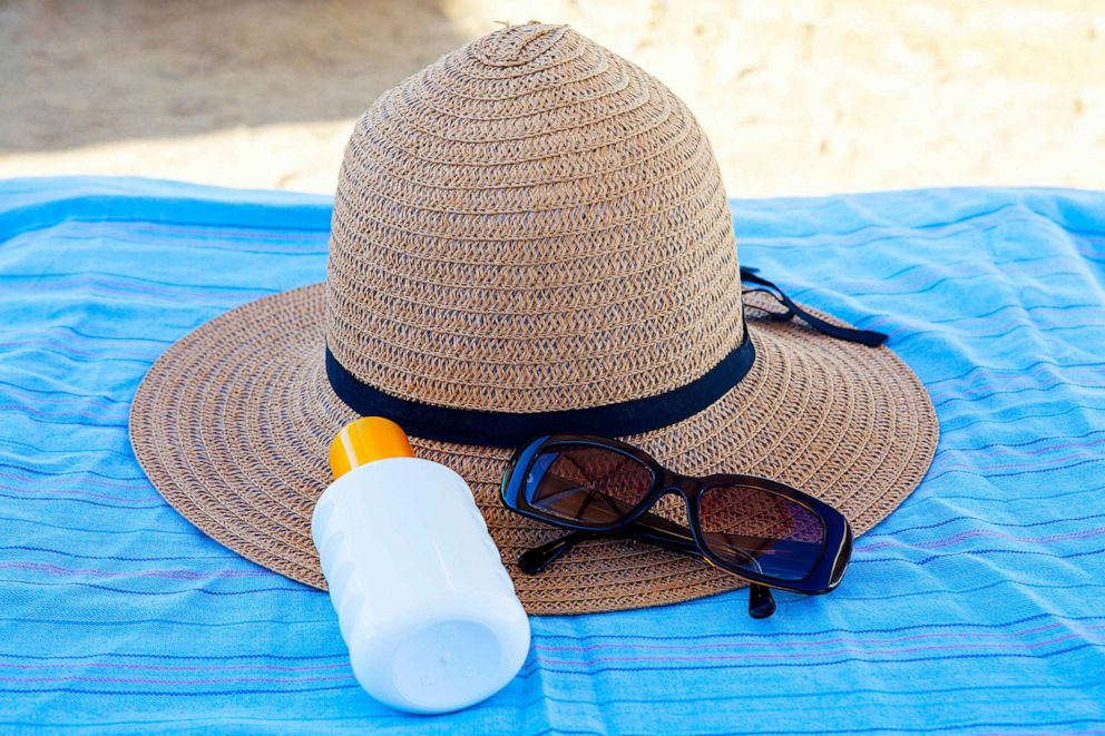 STOCK PHOTO: Sunscreen, hat and glasses on beach