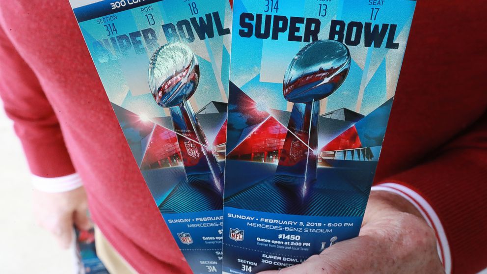 A football fan shows off his Super Bowl tickets after picking them up at the Mercedes-Benz Stadium ticket window on Jan. 22, 2019, in Atlanta.