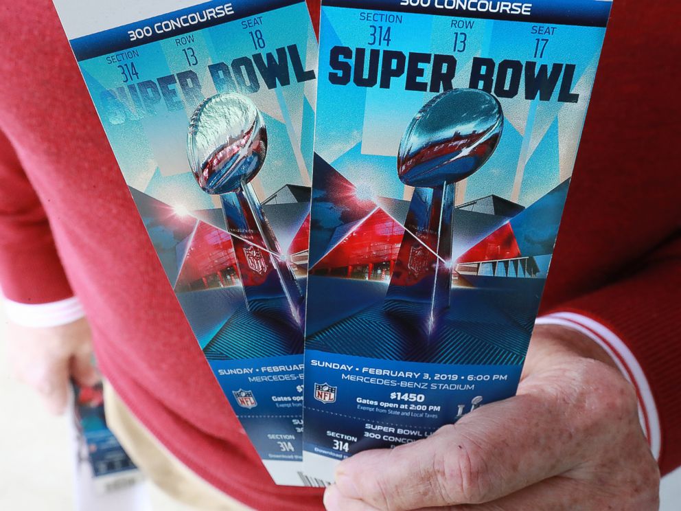 PHOTO: A football fan shows off his Super Bowl tickets after picking them up at the Mercedes-Benz Stadium ticket window on Jan. 22, 2019, in Atlanta.