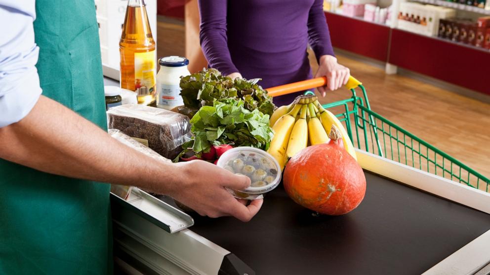 PHOTO: In this undated stock photo, a customer buys produce at the checkout line of a supermarket.