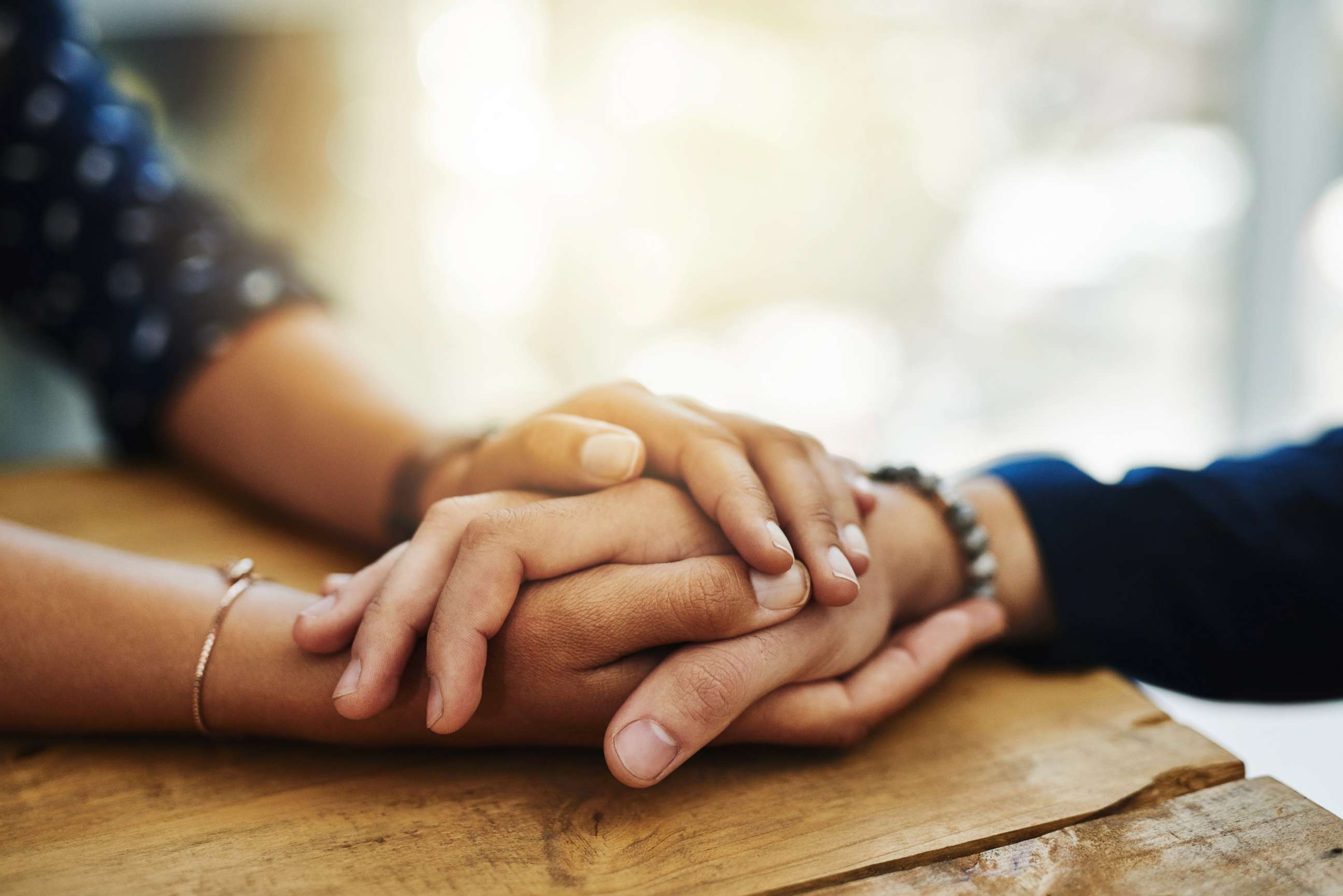 PHOTO: An undated stock photo depicts two people holding hands in comfort.