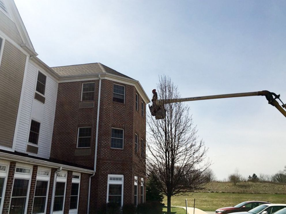 PHOTO: Charley Adams, 45, uses his company's bucket truck to visit his 80-year-old mother quarantined on the 3rd floor of a nursing home in New Middletown, Ohio, March 22, 2020.