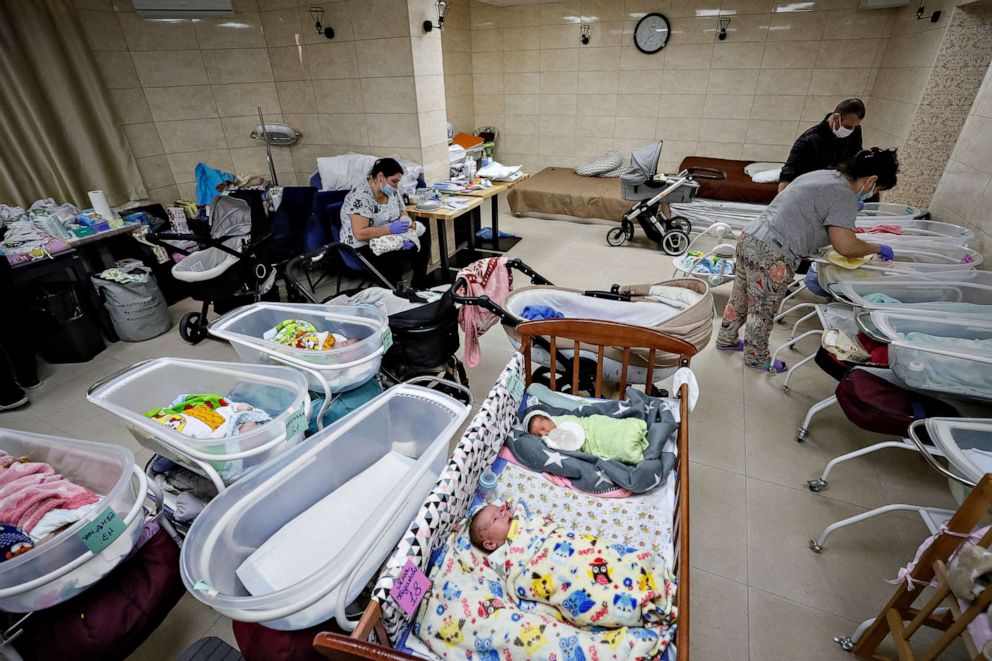 PHOTO: Nurses look after babies born by surrogates inside a special shelter owned by BioTexCom clinic in a residential basement on the outskirts of Kyiv, Ukraine, March 15, 2022.
