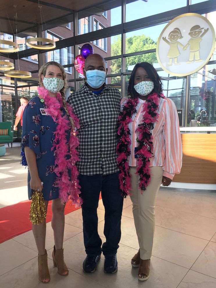 PHOTO: Susan Ellis and Rodney and Tia Wimbush pose together at a welcome back ceremony at Children's Healthcare of Atlanta.