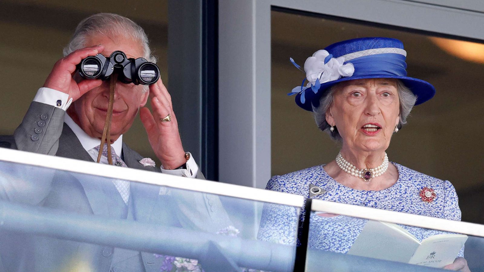 PHOTO: Prince Charles, Prince of Wales watches the racing through binoculars as he and Lady Susan Hussey (Lady-in-waiting to Queen Elizabeth II) attend day 2 of Royal Ascot at Ascot Racecourse, June 15, 2022 in Ascot, England.