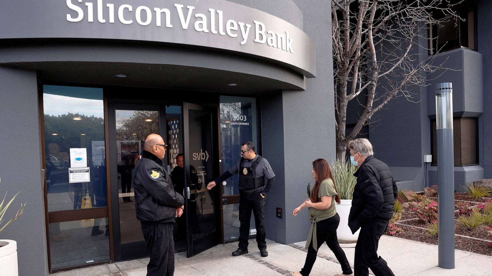 PHOTO: A customer is escorted into the Silicon Valley Bank headquarters in Santa Clara, Calif., March 13, 2023.