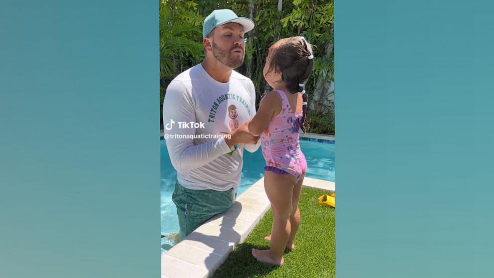 PHOTO: Tyler Reed, the owner of Triton Aquatic Training in Tampa, says a "mermaid mantra" with a 2-year-old girl.