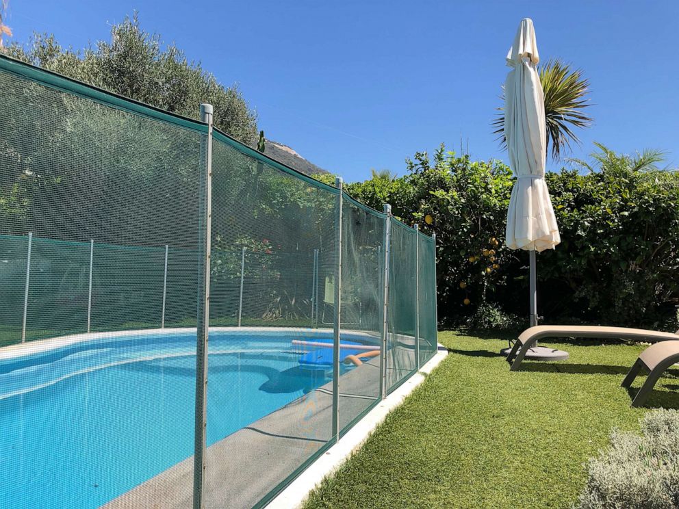 PHOTO: Home swimming pool in garden with safety fence