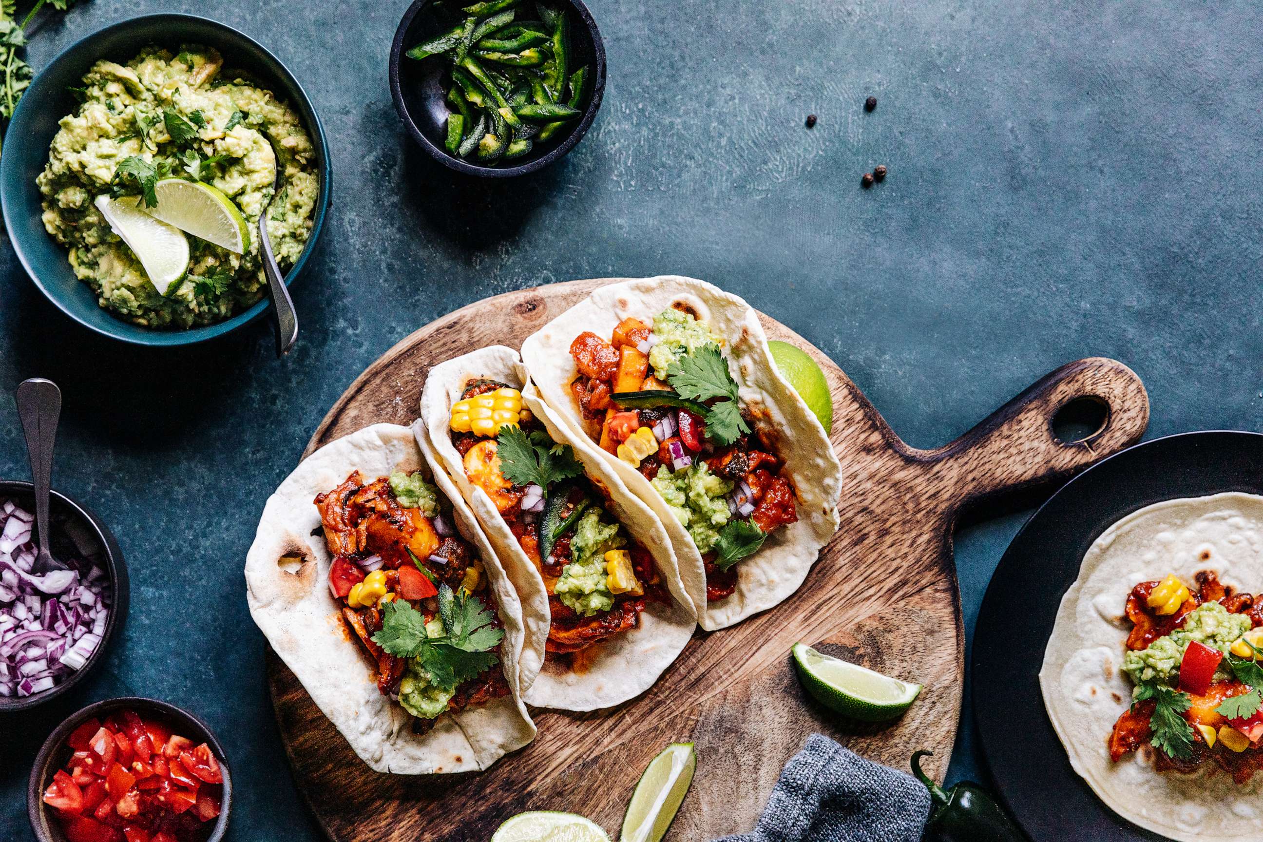PHOTO: In an undated stock photo, three tacos are seen on a wooden board.