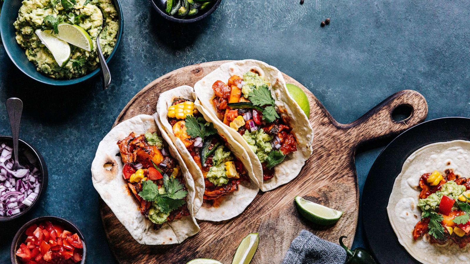 PHOTO: In an undated stock photo, three tacos are seen on a wooden board.