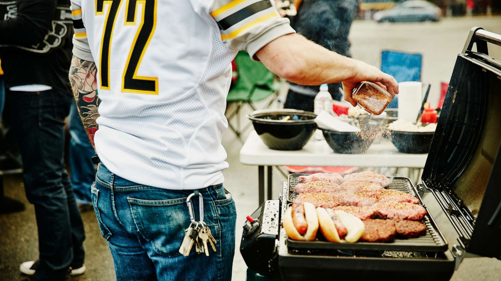 PHOTO: People grill at tailgating party before football game in an undated stock photo.