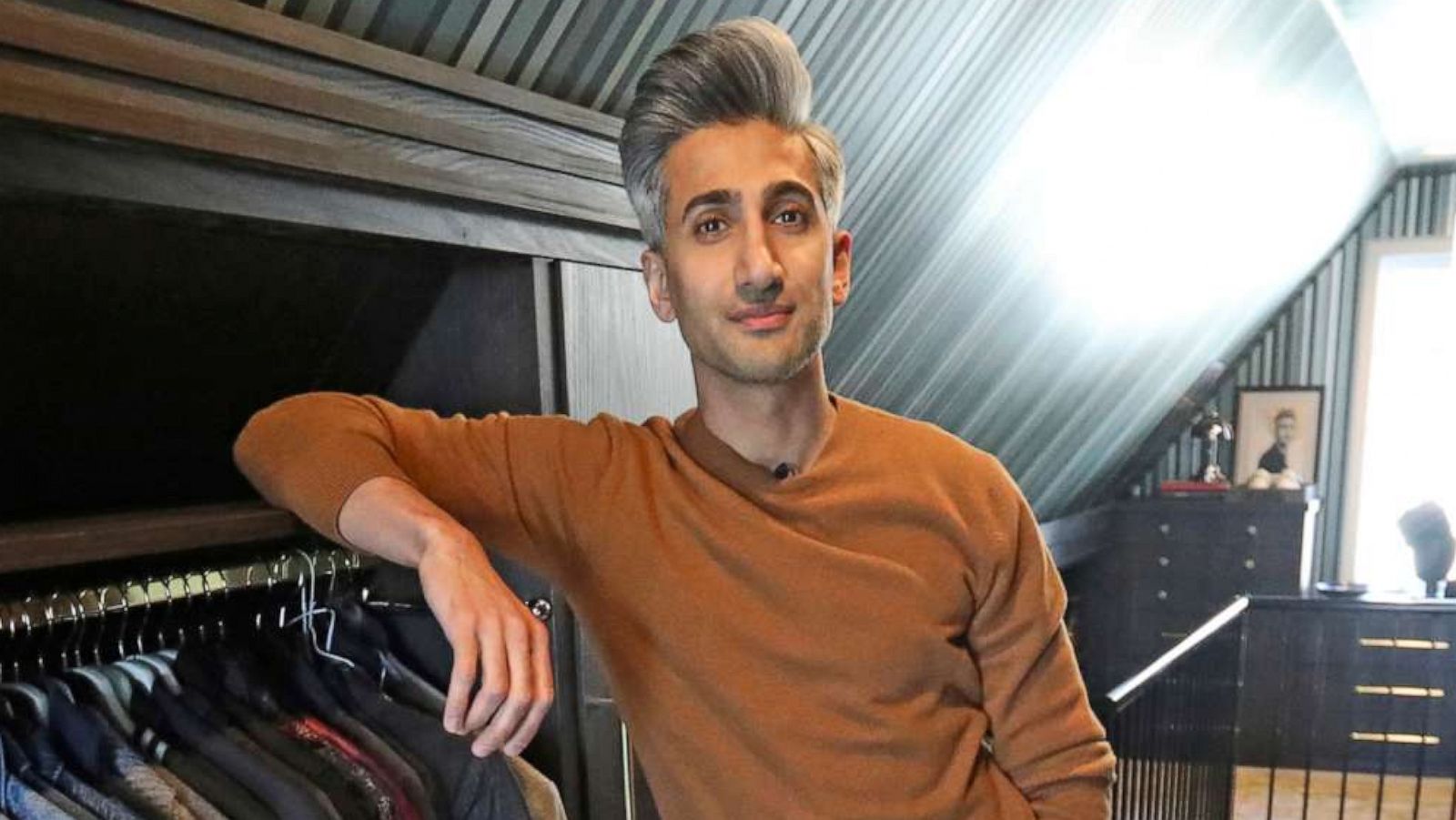 PHOTO: Tan France, a cast member on the Netflix series "Queer Eye," poses among his clothes in the attic of his home in Salt Lake City.