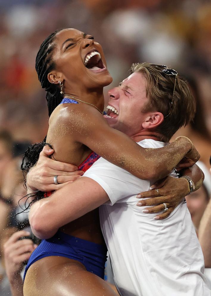 PHOTO: Tara Davis-Woodhall of Team United States celebrates winning the gold medal with husband Hunter Woodhall after competing in the Women's Long Jump Final on day thirteen of the Olympic Games Paris 2024 at Stade de France on Aug. 8, 2024 in Paris.