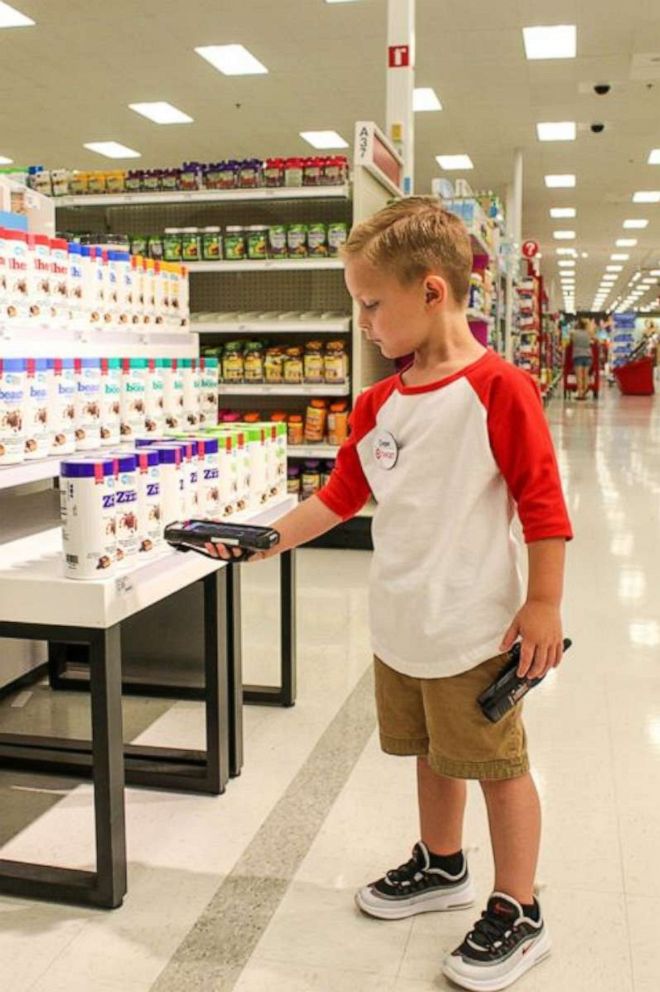 PHOTO: Cooper's "duties" as a Target employee for the day included scanning merchandise on the shelves.