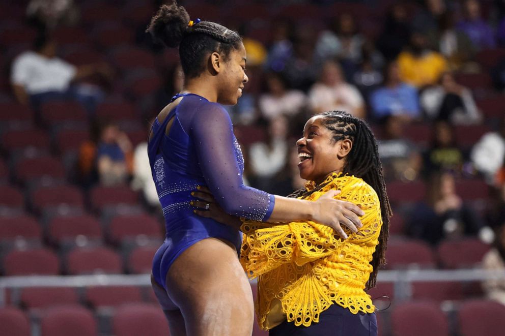 PHOTO: Fisk University coach Corrinne Tarver, right, embraces Kiara Richmon after her balance-beam performance during a Super 16 gymnastics meet, Jan. 6, 2023, in Las Vegas.