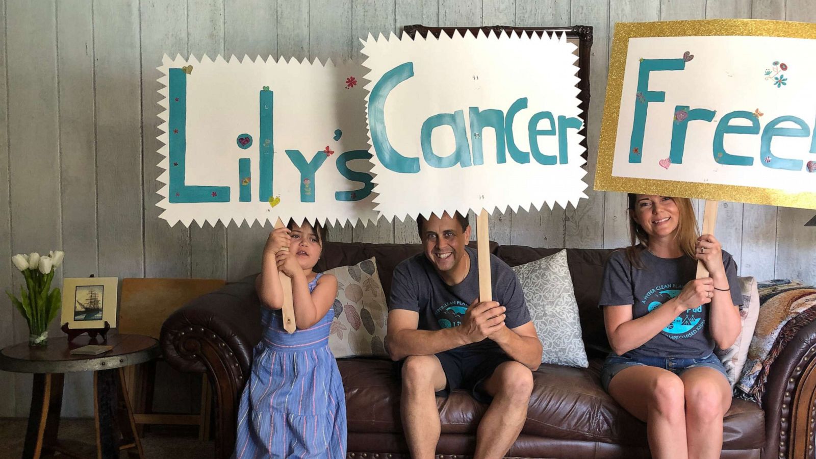 PHOTO: Lily with her parents Brad and Peggy Taylor after her last chemotherapy treatment in April 2020.