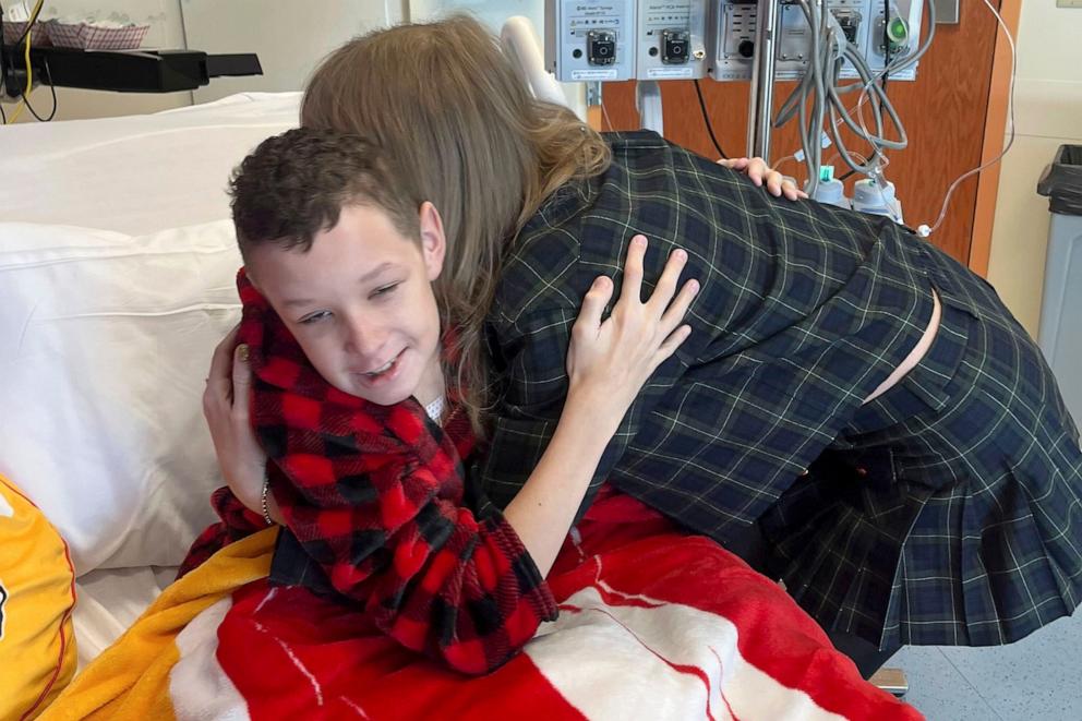 PHOTO: In this image provided by Cassie Thomas, Beckett Thomas, 13, who is a patient at Children's Mercy Hospital in Kansas City, Mo., is hugged by Taylor Swift, on Dec. 12, 2024. 