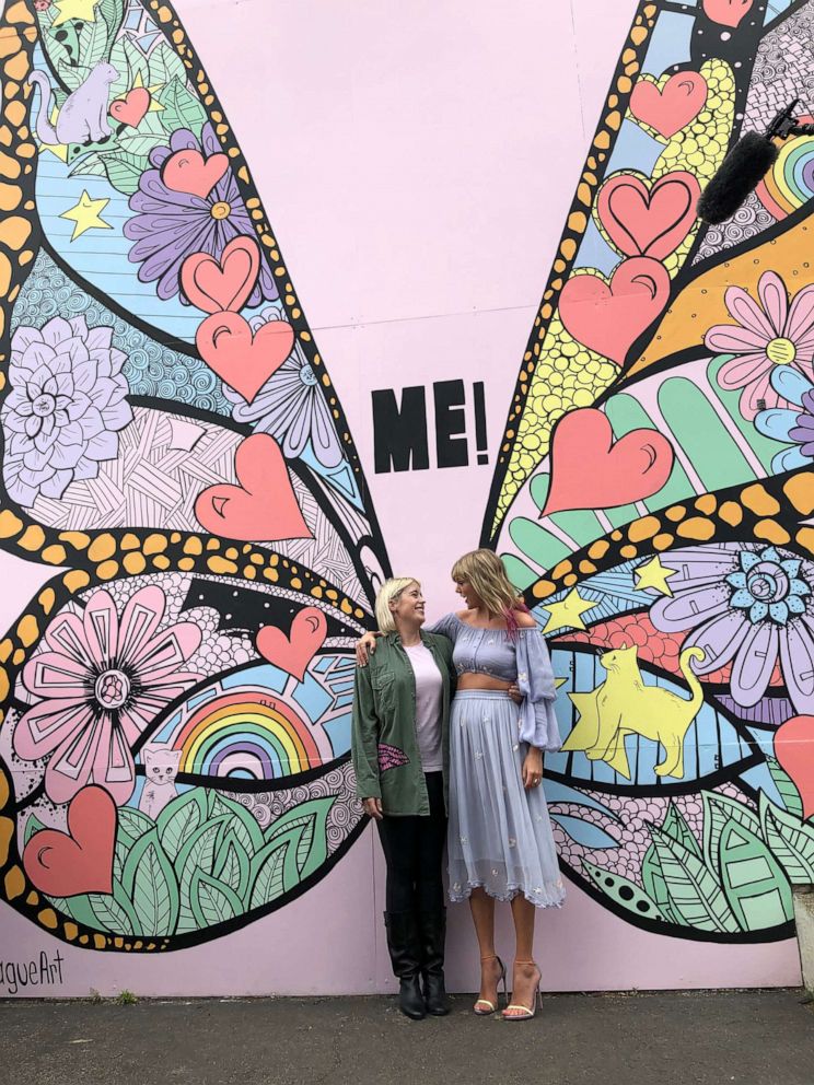 PHOTO: Taylor Swift poses with artist Kelsey Montague in front of her new mural, "What Lifts You Up," in Nashville, April 25, 2019.