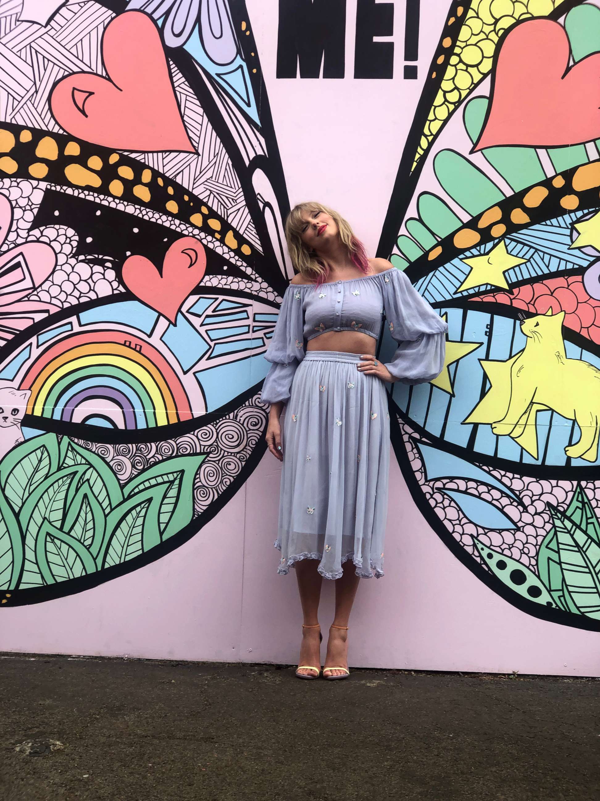 PHOTO: Taylor Swift poses in front of a butterfly mural in Nashville, Tenn., April 25, 2019. The mural offers clues to her forthcoming music.