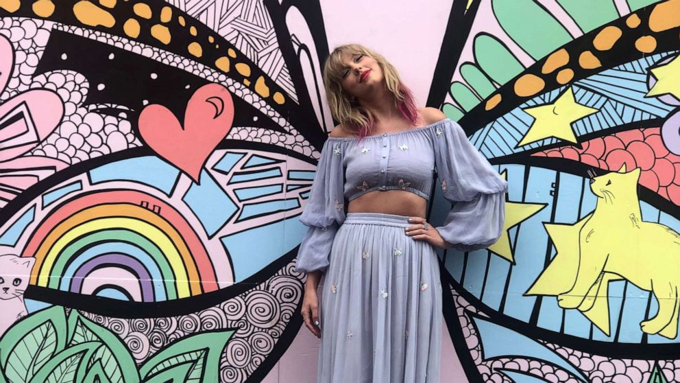 PHOTO: Taylor Swift poses in front of a butterfly mural in Nashville, Tenn., April 25, 2019. The mural offers clues to her forthcoming music.