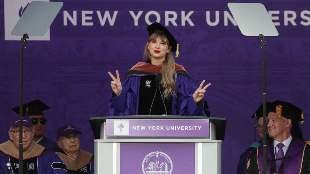 PHOTO: Singer Taylor Swift gestures while speaking after receiving her Honorary Doctorate in Fine Arts during the New York University graduation ceremony at Yankee Stadium in New York, May 18, 2022.