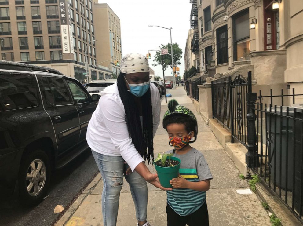 PHOTO: Dawn Thompson delivers a plant to a student during the reopening phase of New York, in Brooklyn, New York.