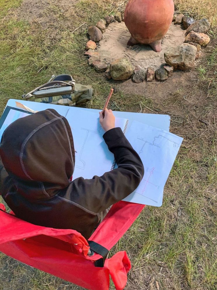 PHOTO: Lindsey Earle, a fourth grade teacher at Prairie Hill Waldorf School in Pewaukee, Wisconsin, built an outdoor structure for her 13 students amid the novel coronavirus pandemic. Here, one of Earle's students learns in her class.