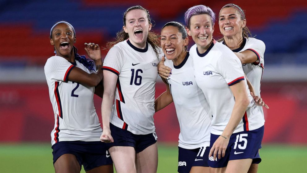 Team USA, including Megan Rapinoe, 2nd right, and Alex Morgan, right, celebrate their victory in the penalty shoot out after the women's match between Netherlands and United States at the Tokyo 2020 Olympic Games on July 30, 2021, in Yokohama, Japan.