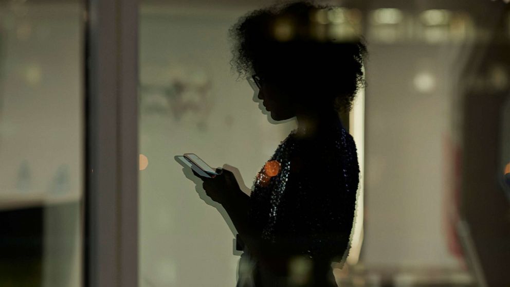 PHOTO: An undated stock photo shows the silhoutte of a person looking at their phone.