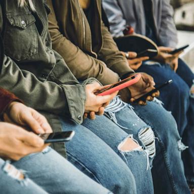 PHOTO: Young people using their mobile phones.