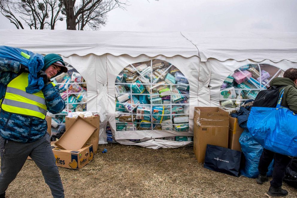 PHOTO: A tent full of diapers is seen at the aid collecting point on the outskirts of Przemysl, Poland, March 3, 2022. Thousands of exhausted refugees fleeing war are arriving to the Polish border town from Ukraine.