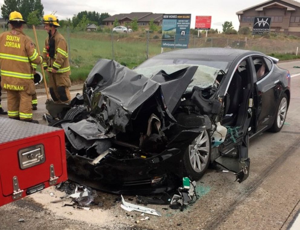 PHOTO: Firemen are seen at a traffic collision involving a Tesla Model S sedan with a fire department mechanic truck stopped at a red light in South Jordan, Utah, May 11, 2018.
