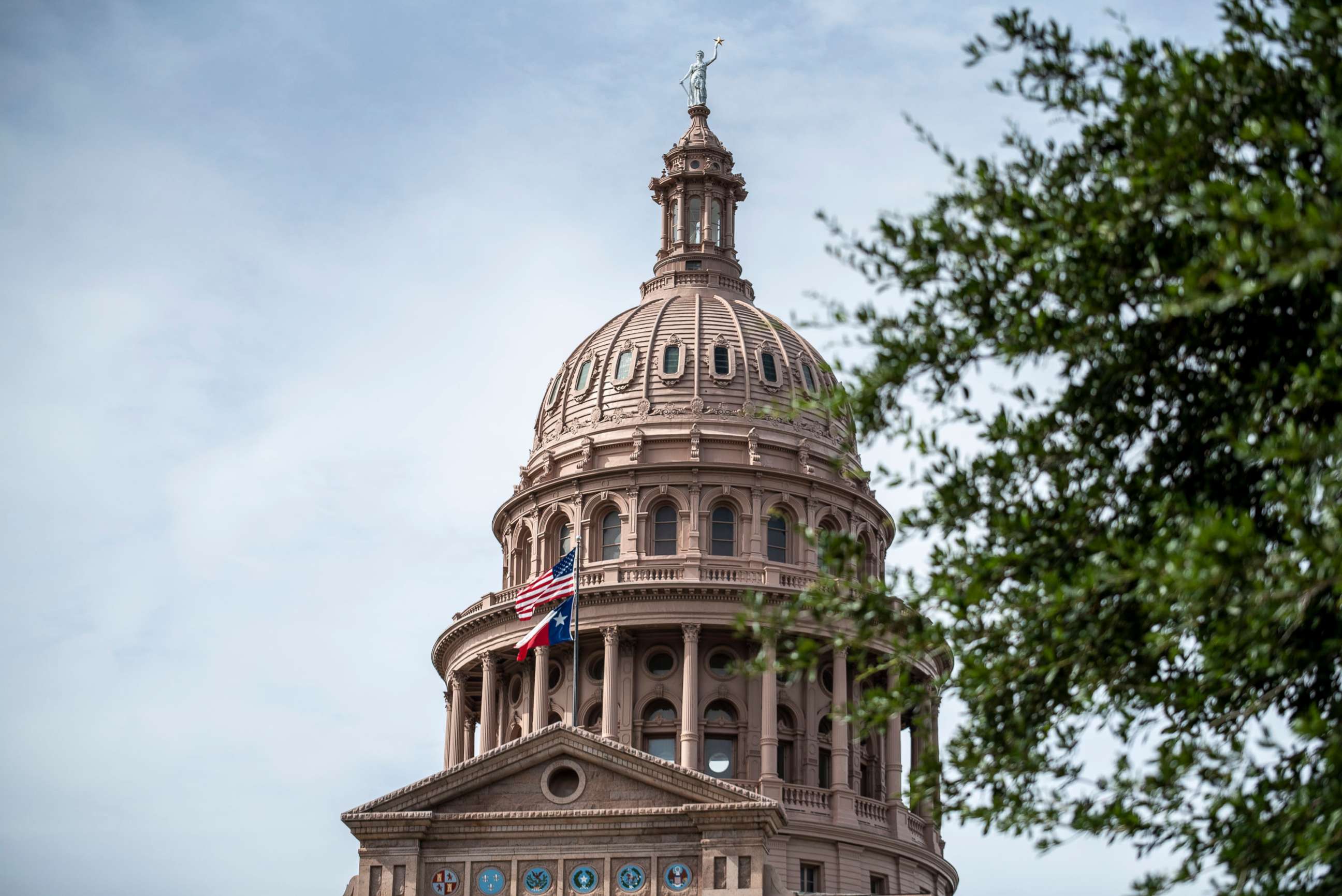 PHOTO: In this July 12, 2021, file photo, the U.S. and Texas state flags fly outside the state Capitol building in Austin, Texas.