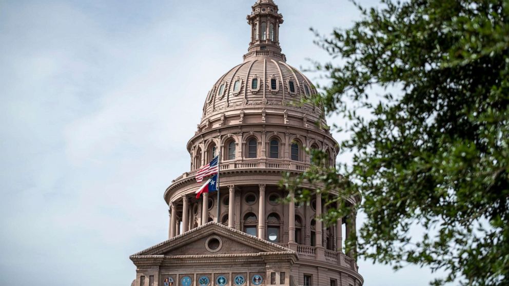 PHOTO: In this July 12, 2021, file photo, the U.S. and Texas state flags fly outside the state Capitol building in Austin, Texas.