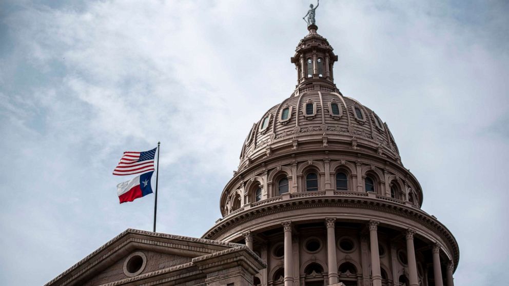 PHOTO: The U.S. and Texas state flags fly over the state Capitol building in Austin, Texas. July 12, 2021. 