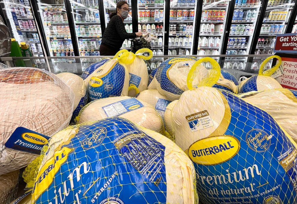 PHOTO: A shopper walks past turkeys for sale in a grocery store ahead of the Thanksgiving holiday in Los Angeles,  Nov. 11, 2021.