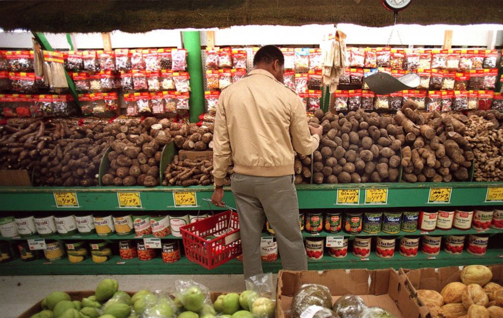 PHOTO: A shopper inspects the yams while food shopping at in Boston, April 14, 2021.