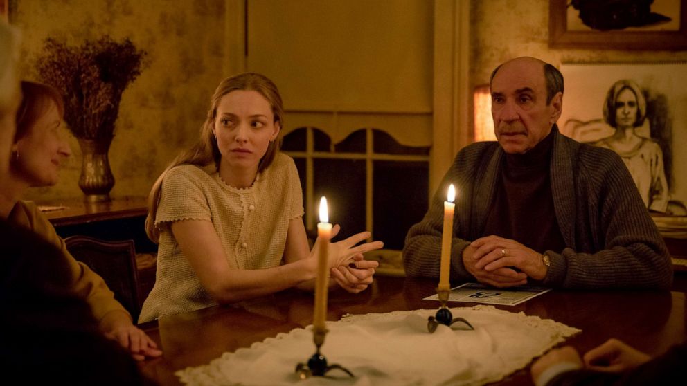 Amanda Seyfried, as Catherine Clare, and F. Murray Abraham, as Floyd DeBeers, in a scene from "Things Heard and Seen."