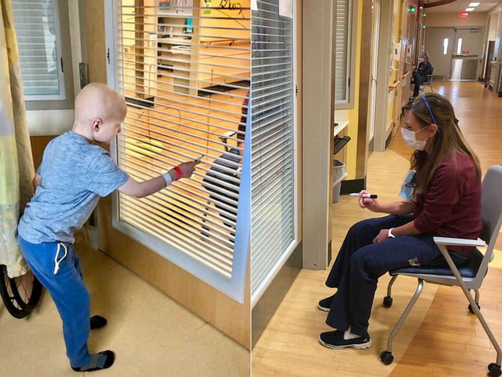 PHOTO: Nurse Allie Schulten plays tic-tac-toe with cancer patient Grant Wolf through a hospital room window, hoping to cheer up the seven-year-old while social distancing.