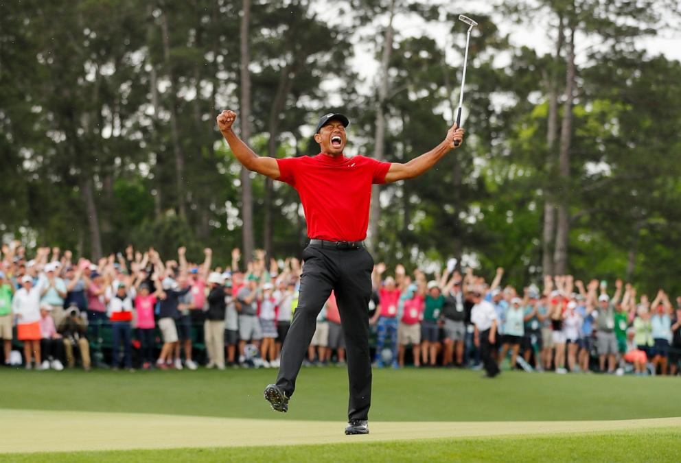 PHOTO: Tiger Woods of the United States celebrates after sinking his putt on the 18th green to win during the final round of the Masters at Augusta National Golf Club, April 14, 2019, in Augusta, Ga. 