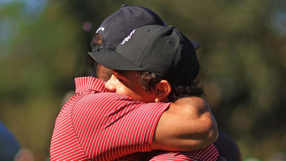 PHOTO: Tiger Woods of the United States reacts with his son Charlie Woods after holing out on the fourth hole during the second round of the PNC Championship at Ritz-Carlton Golf Club on Dec. 22, 2024 in Orlando, Fla.