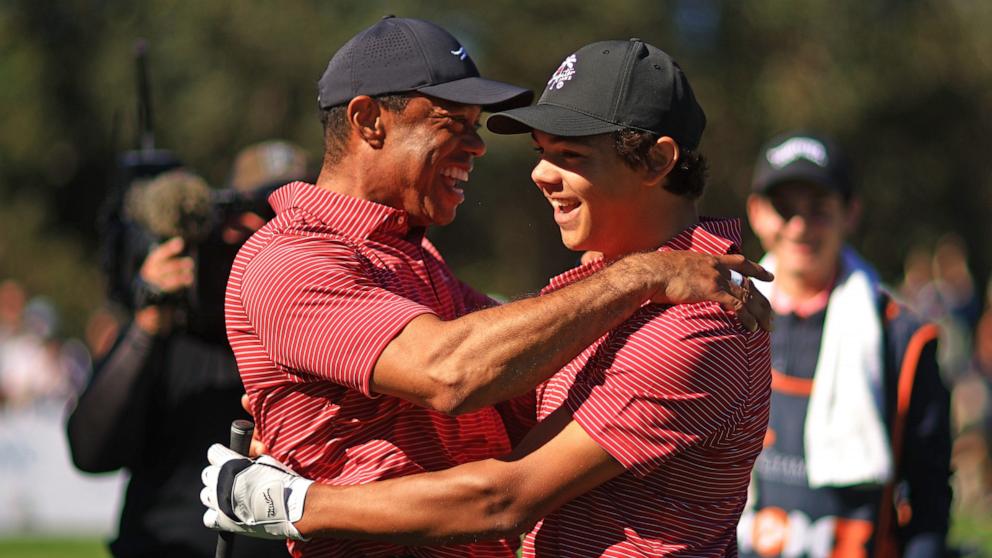 PHOTO: Tiger Woods of the United States reacts with his son Charlie Woods after holing out on the fourth hole during the second round of the PNC Championship at Ritz-Carlton Golf Club on Dec. 22, 2024 in Orlando, Fla.