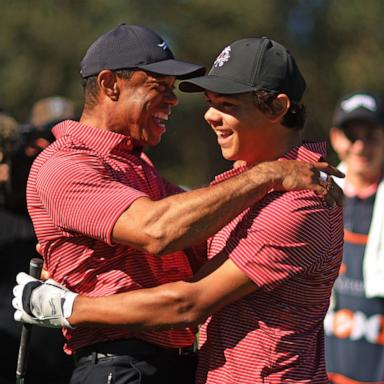 PHOTO: Tiger Woods of the United States reacts with his son Charlie Woods after holing out on the fourth hole during the second round of the PNC Championship at Ritz-Carlton Golf Club on Dec. 22, 2024 in Orlando, Fla.